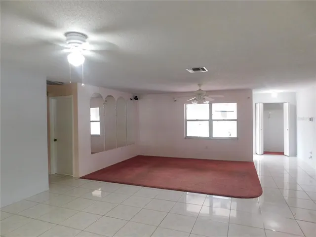 a view of a room with window and chandelier fan