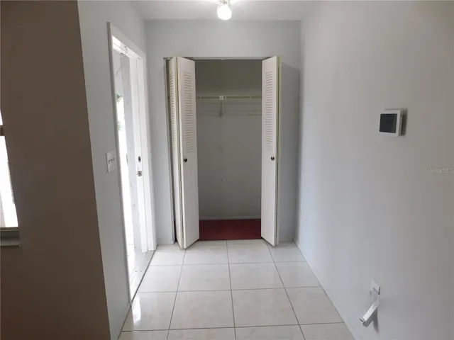 an empty room with a bathroom and mirror