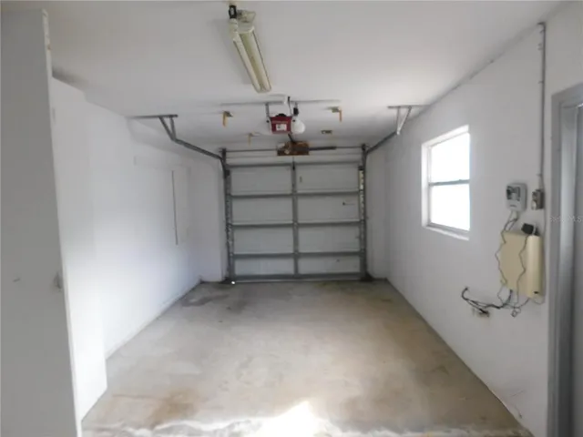 a view of a livingroom with stairs and window