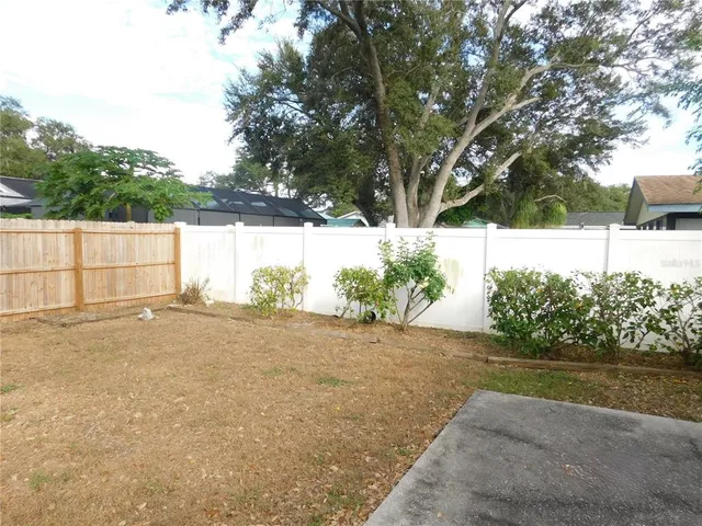 a backyard of a house with lots of green space