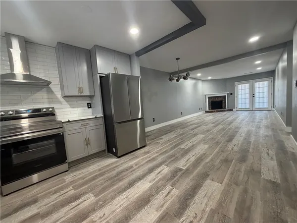 a kitchen with granite countertop a refrigerator stove and microwave