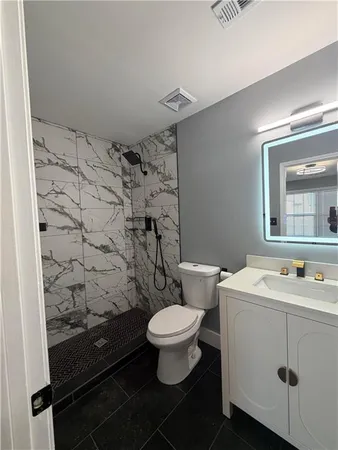 a bathroom with a sink toilet and a mirror