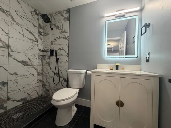 a white toilet sitting next to a bathroom sink