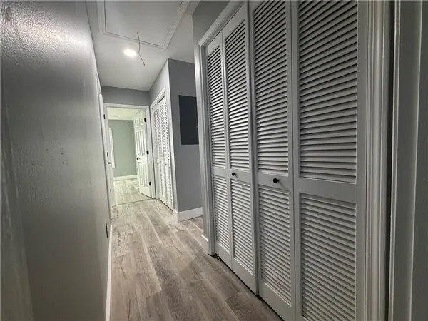 a view of hallway with wooden floor