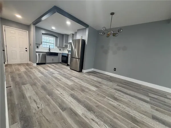 a view of a kitchen with a sink dishwasher a kitchen counter top space cabinets and stainless steel appliances