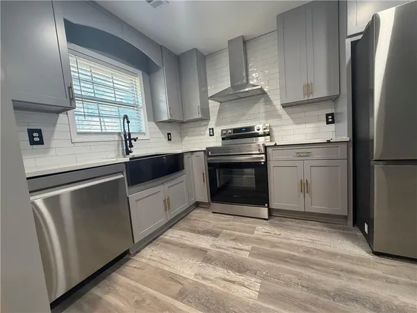a kitchen with stainless steel appliances granite countertop a sink stove and refrigerator