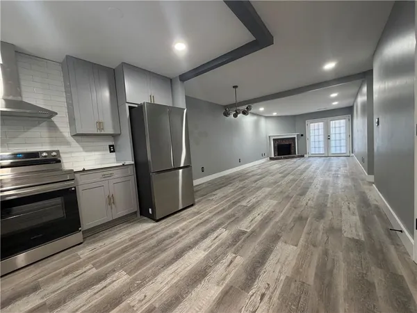a kitchen with a refrigerator and a stove top oven