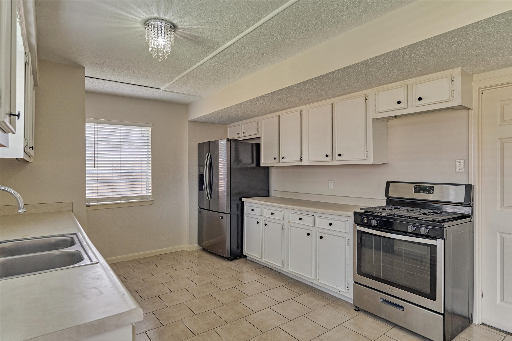 29318 Waltham Street Spring, TX 77386 - Photo 15 of 28 a kitchen with cabinets appliances and a window
