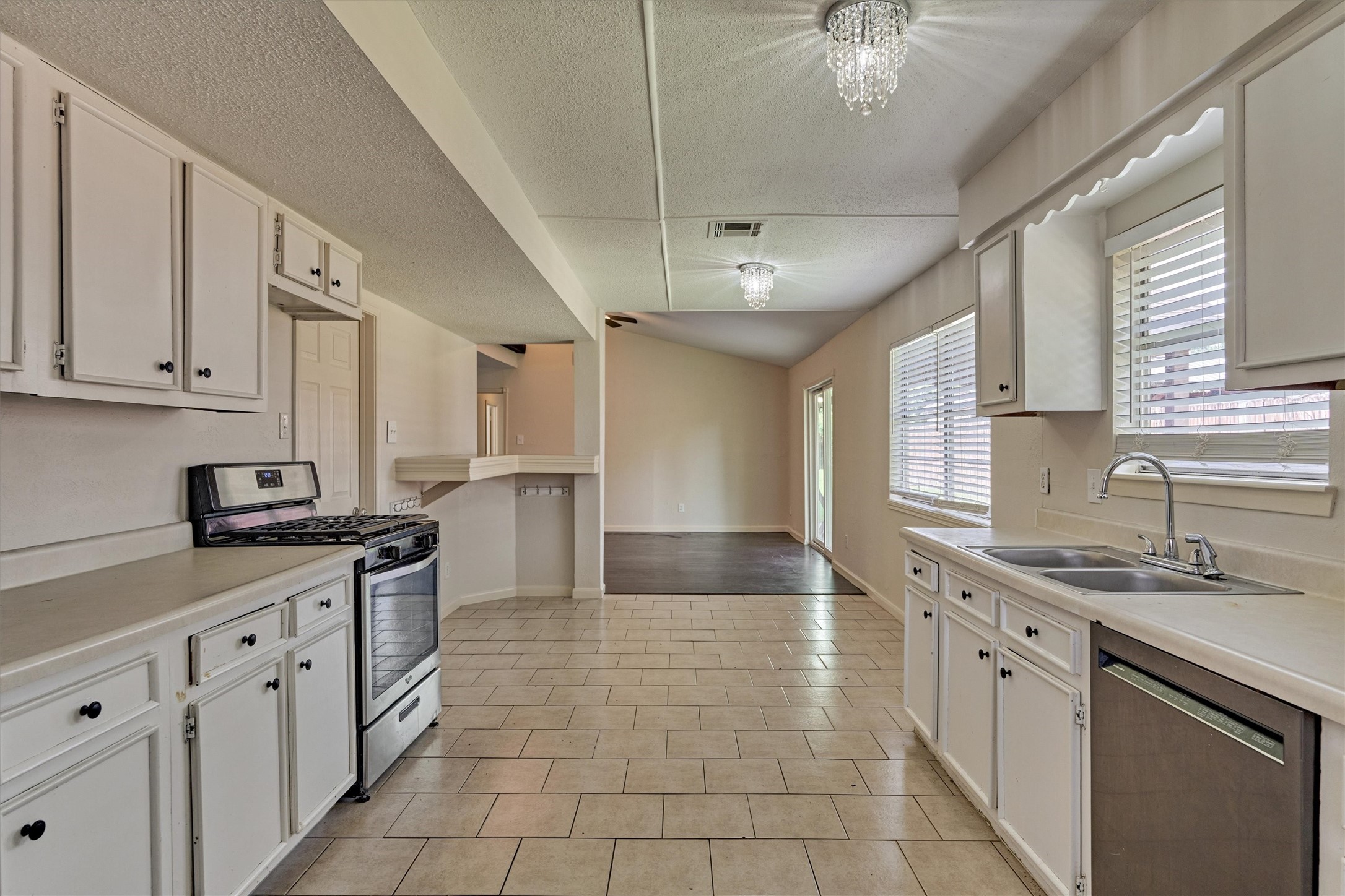 29318 Waltham Street Spring, TX 77386 - Photo 16 of 28 a kitchen with stainless steel appliances granite countertop a sink stove and cabinets