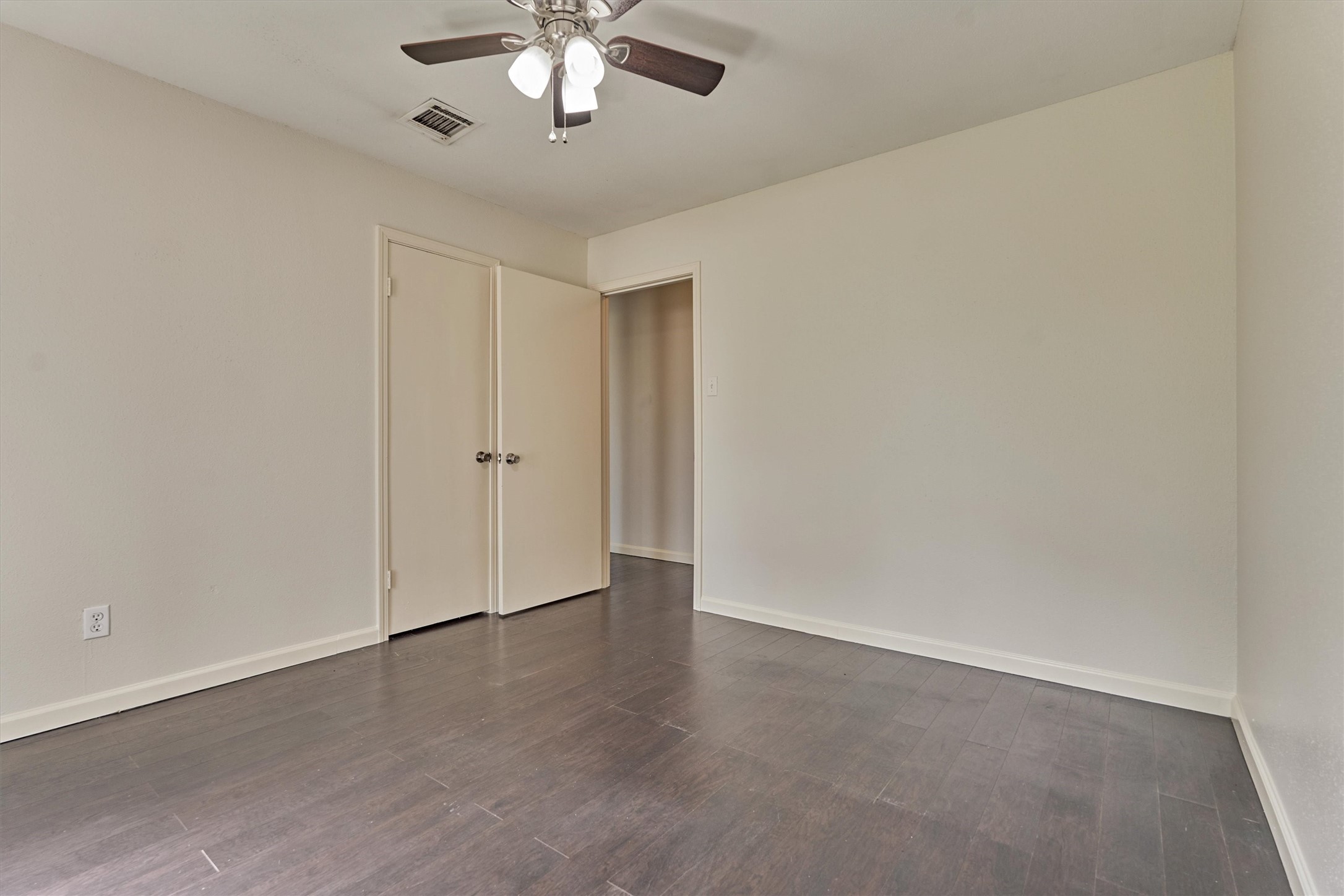 29318 Waltham Street Spring, TX 77386 - Photo 19 of 28 an empty room with a chandelier fan and windows