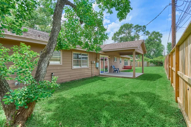 a view of a house with backyard and a hammock
