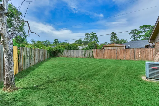 a view of a backyard with wooden fence