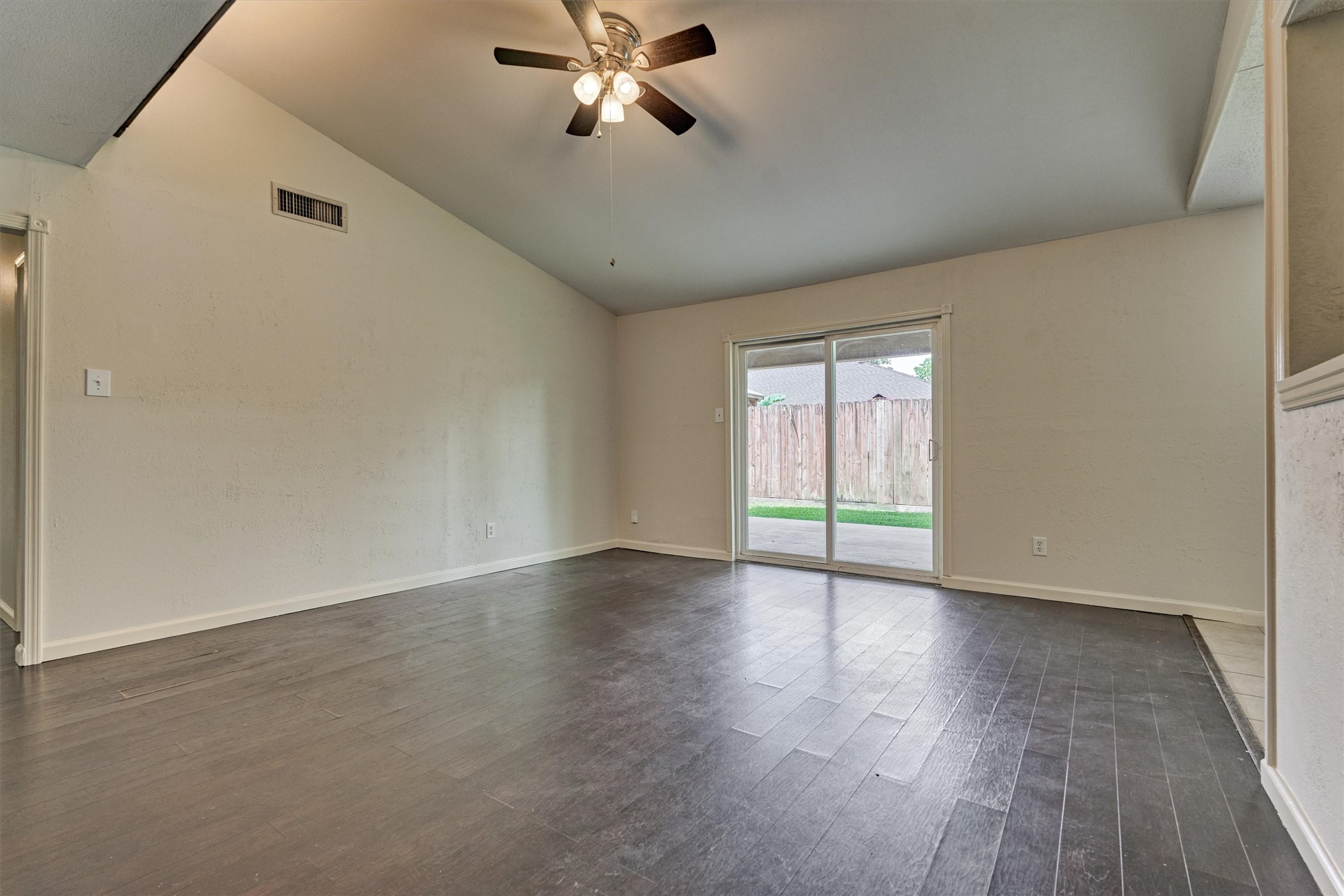 29318 Waltham Street Spring, TX 77386 - Photo 9 of 28 a view of an empty room with wooden floor and a window