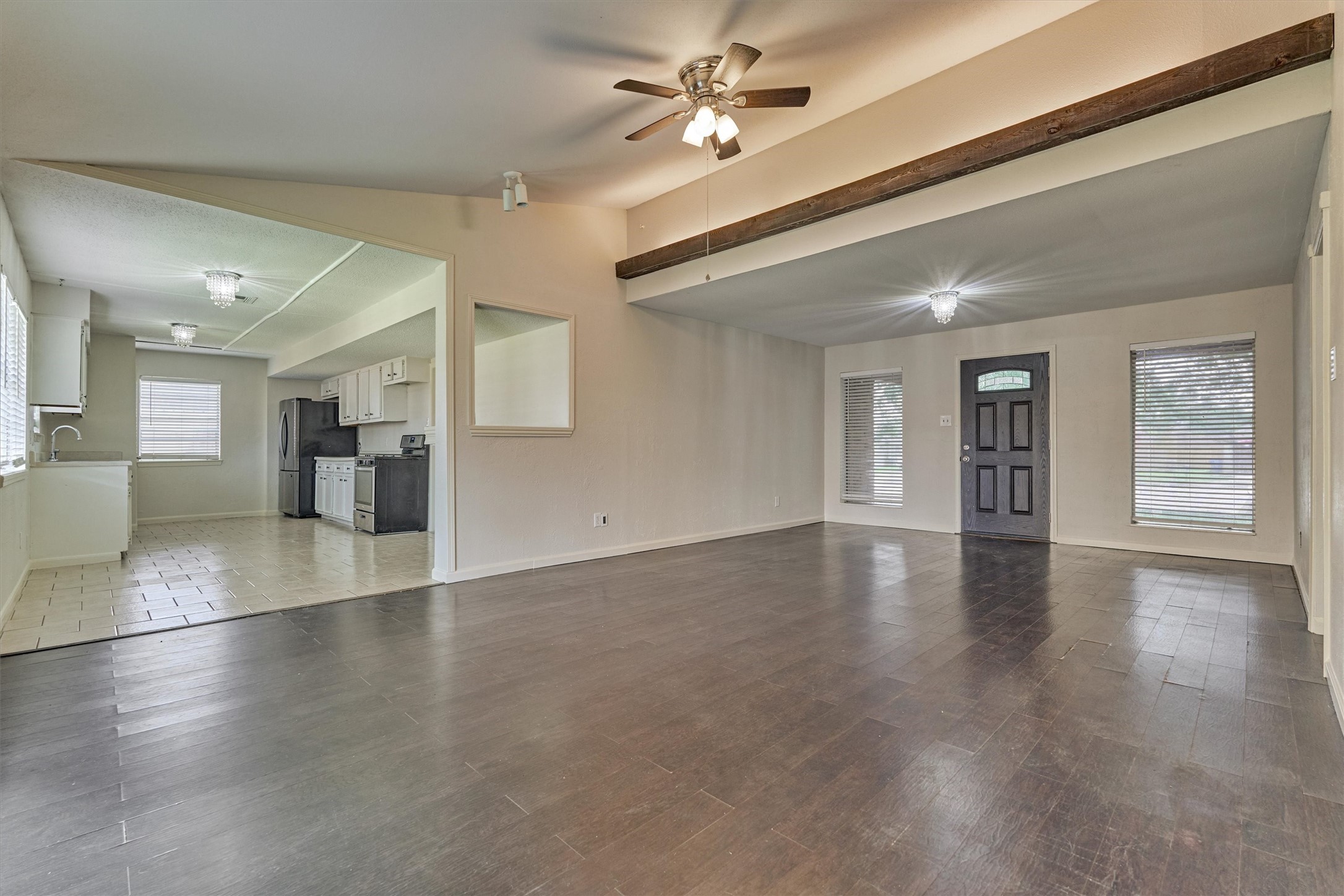 29318 Waltham Street Spring, TX 77386 - Photo 10 of 28 a view of an empty room with wooden floor and a kitchen