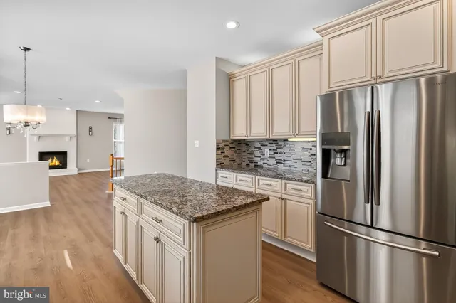 a view of an empty room with a fireplace and a window