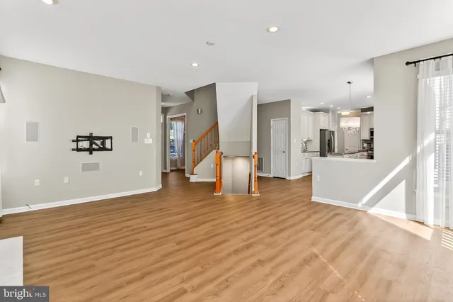 a bathroom with a double vanity sink large mirror and bathtub