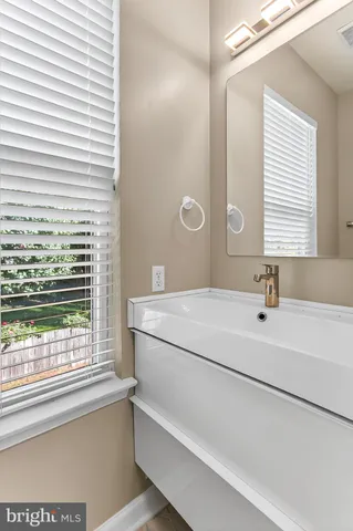 a bathroom with a double vanity sink toilet and shower