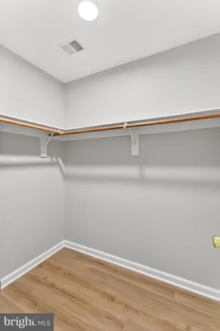 a bathroom with a granite countertop double vanity sink mirror and shower