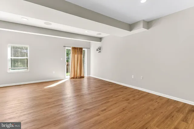 a view of a room with wooden floor