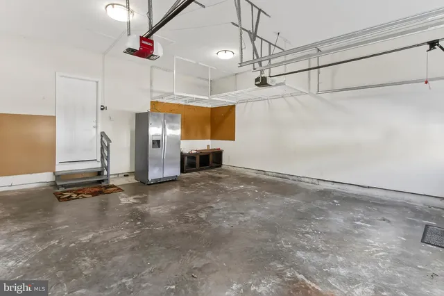a view of a house with wooden walls next to a yard