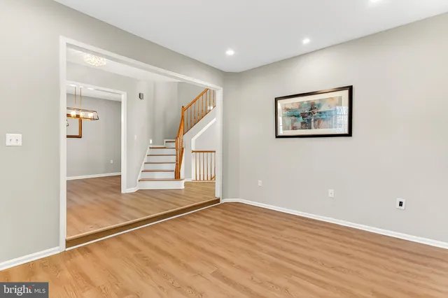 a view of an entryway with wooden floor and door