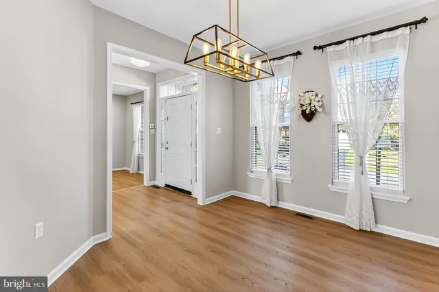 a kitchen with stainless steel appliances granite countertop a refrigerator a stove and a sink