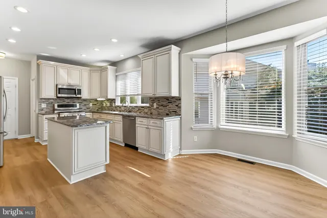 a kitchen with stainless steel appliances granite countertop a stove and a sink