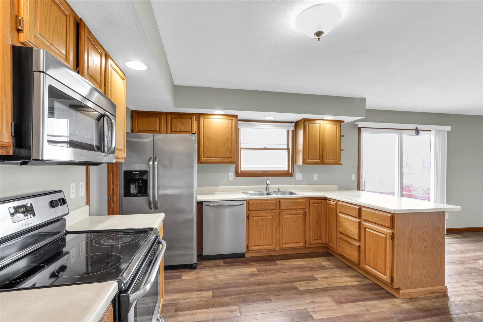 3330 West William Street Champaign, IL 61821 - Photo 16 of 28 a kitchen with stainless steel appliances a sink stove and refrigerator