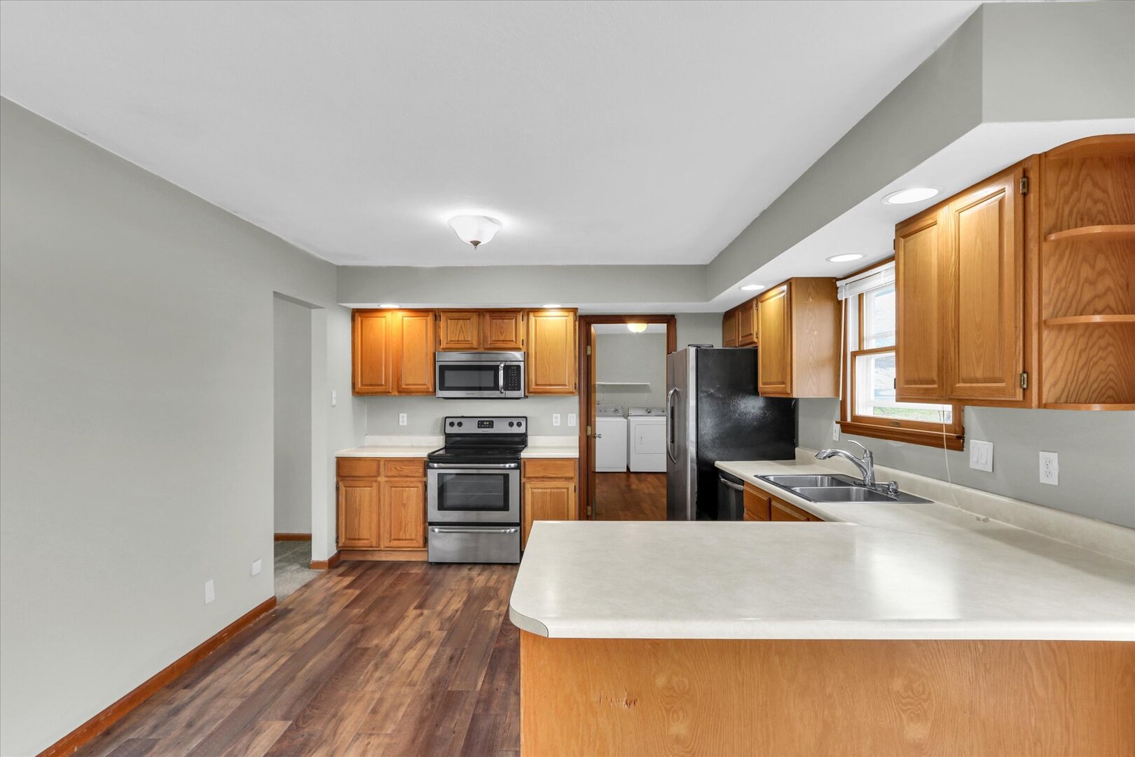 3330 West William Street Champaign, IL 61821 - Photo 18 of 28 a kitchen with stainless steel appliances granite countertop a sink stove and refrigerator