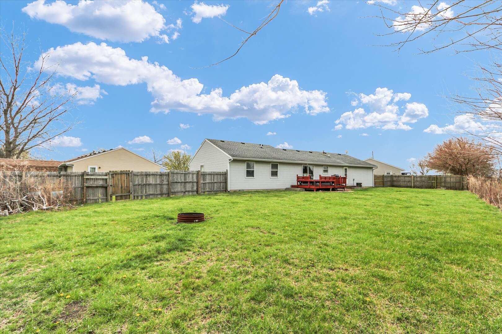 3330 West William Street Champaign, IL 61821 - Photo 6 of 28 a view of a house with a big yard and large trees
