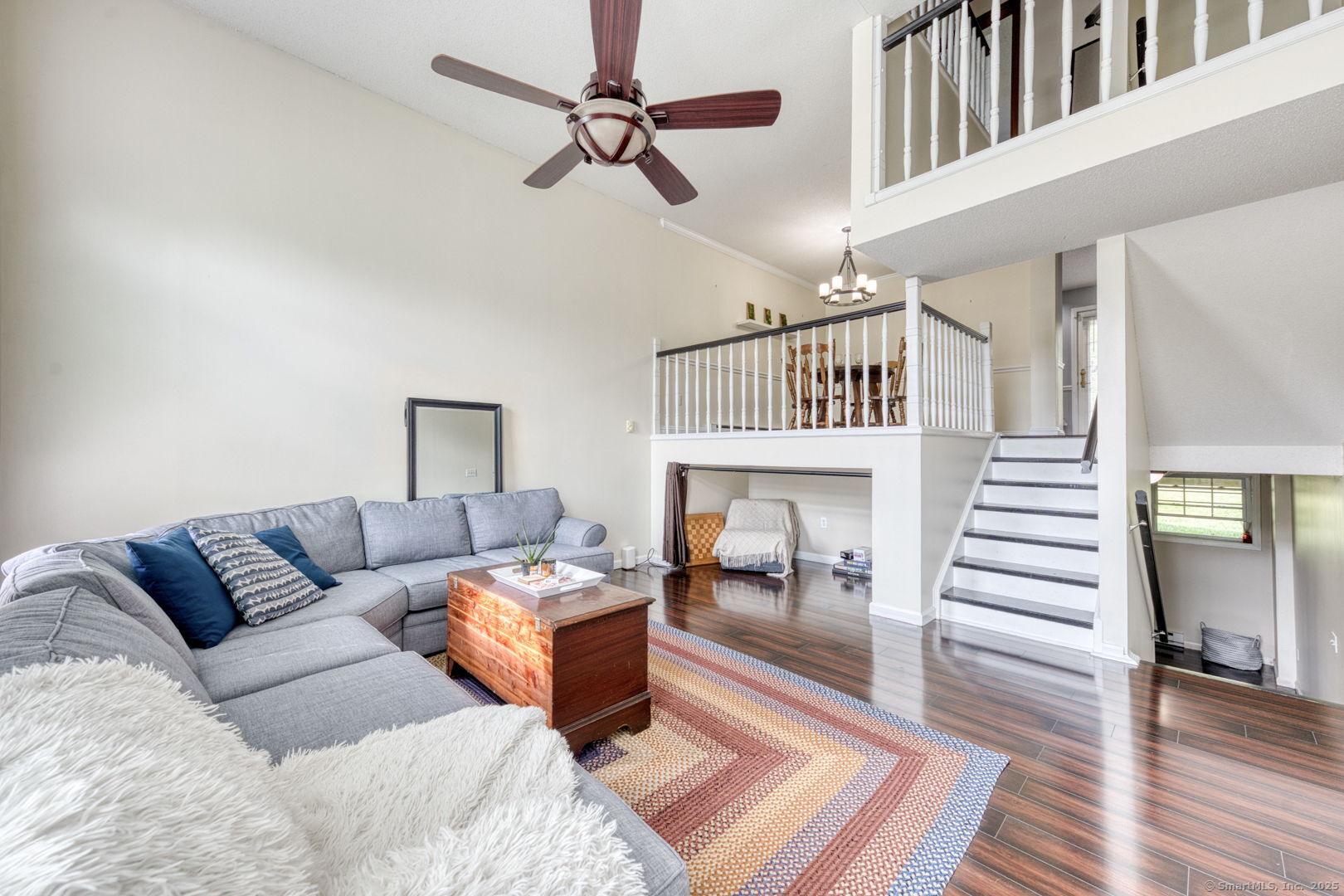 a living room with furniture a fireplace and wooden floor