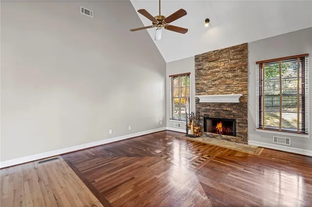 wooden floor fireplace and natural light in room
