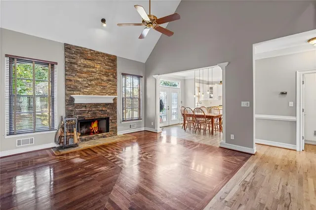 a living room with fireplace furniture and a wooden floor