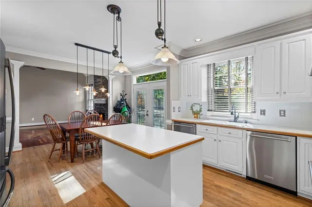 a large kitchen with a table and chairs