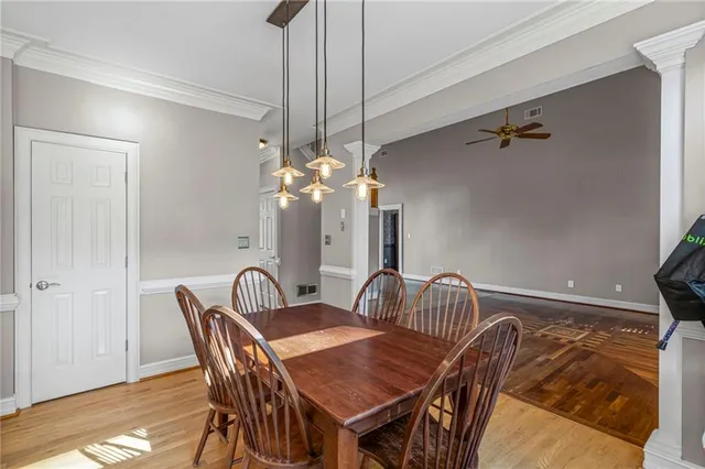 a dining room with furniture and chandelier
