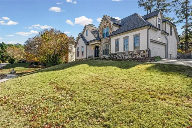 a house that has a big yard and a large tree