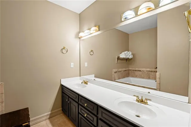 a bathroom with a double vanity sink and a mirror