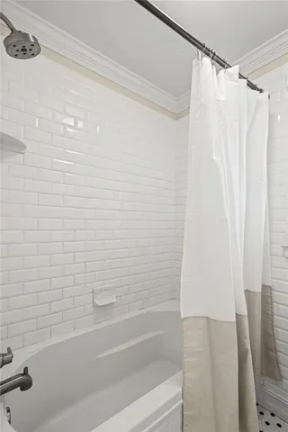 a bathroom with a shower curtain and a bathtub