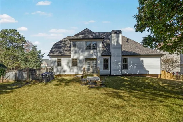 a backyard of a house with a large tree
