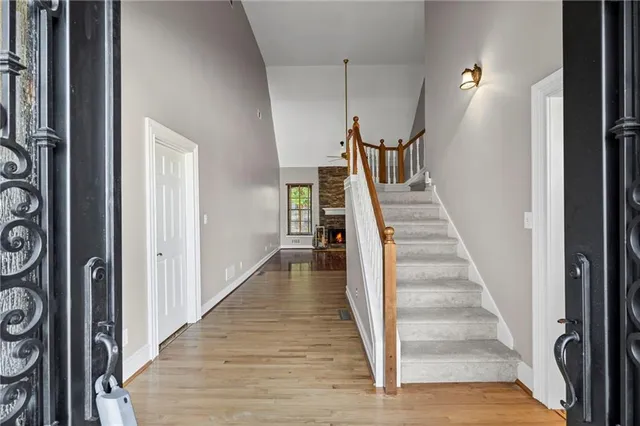 a view of a hallway with wooden floor and entryway