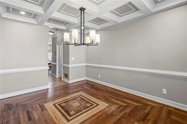 a view of empty room with wooden floor and window