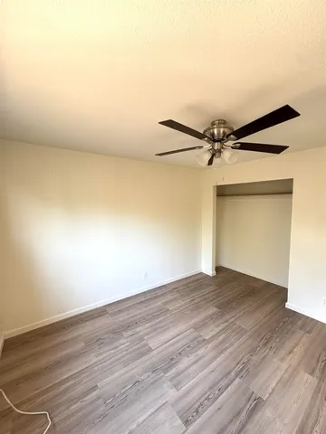a view of a room with wooden floor
