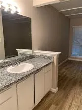 a bathroom with a granite countertop sink and a granite