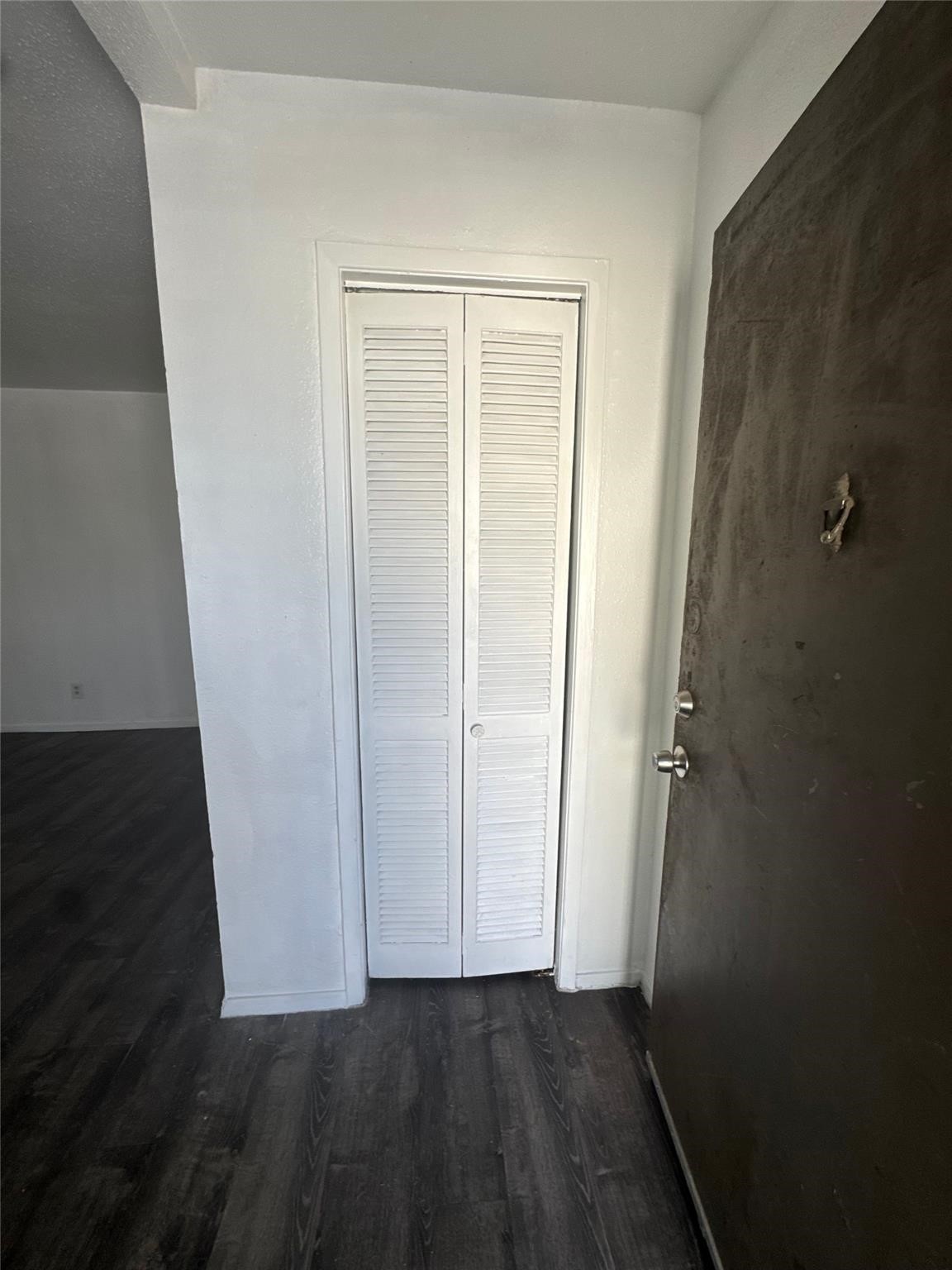 6200 West Tidwell Road, Unit 1205 Houston, TX 77092 - Photo 9 of 14 an empty room with wooden floor and closet