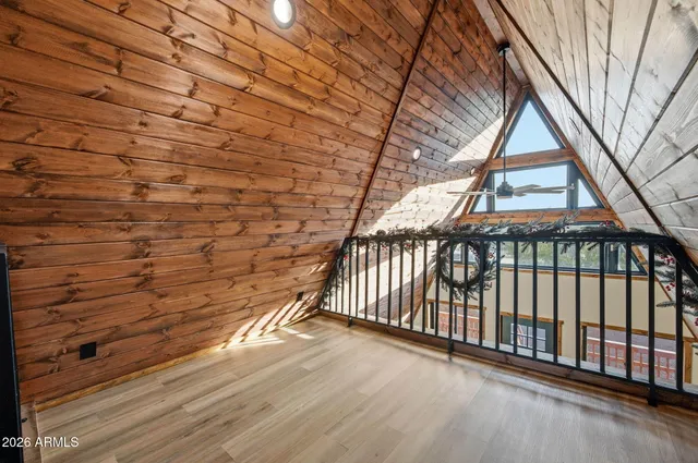 a bedroom with a bed and a ceiling fan