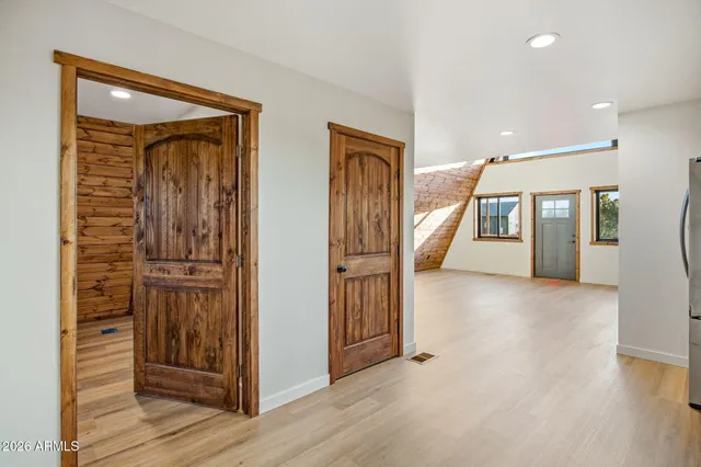 a view of an empty room and wooden floor