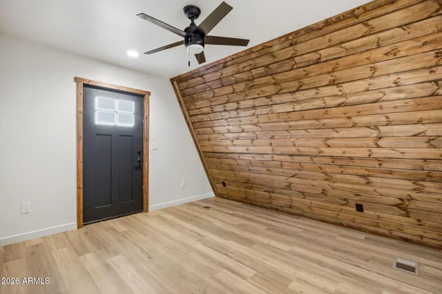 a view of an entryway with wooden floor