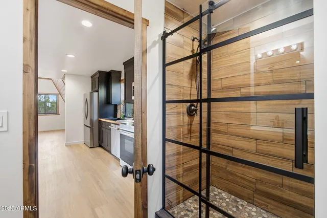 a kitchen with granite countertop a refrigerator stove top oven and sink