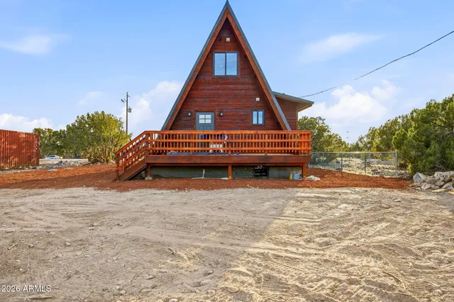 a view of backyard with wooden fence