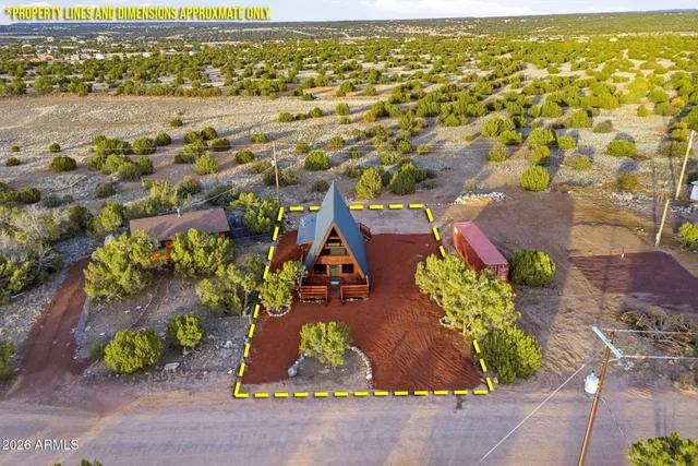 view of a house with a yard and a garden